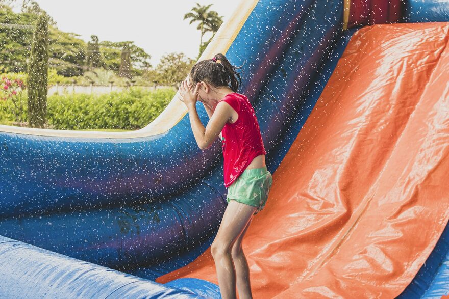 A girl splashing down our sparkle water slide